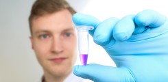 Scientist holds a tube with a sample